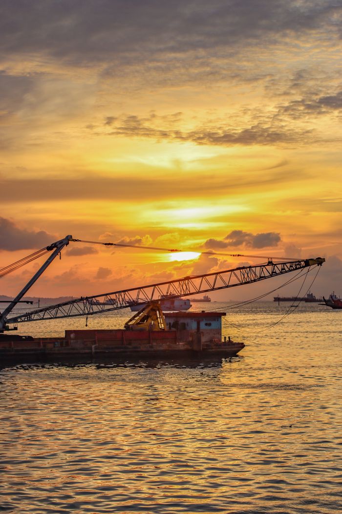 A stunning sunset view over a ship in Kepulauan Riau, Indonesia. Perfect for travel or industry themes.